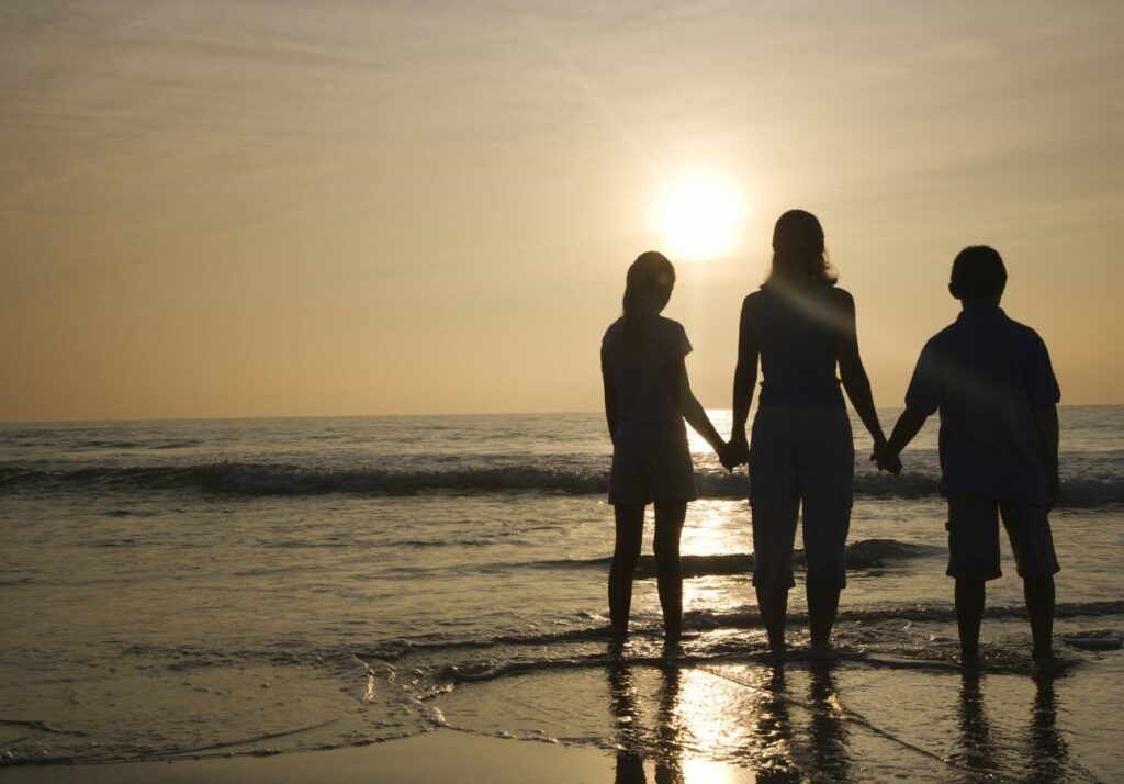 mom at the beach with her 2 kids