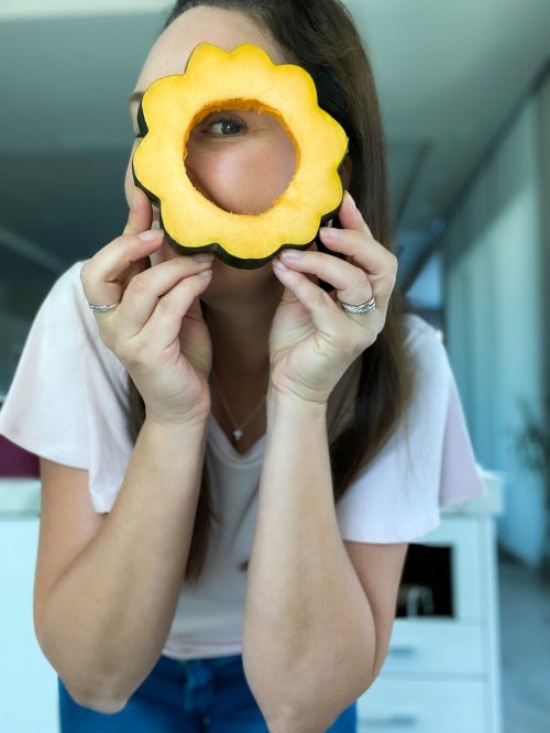 michelle clouse looking through large sunflower cookie